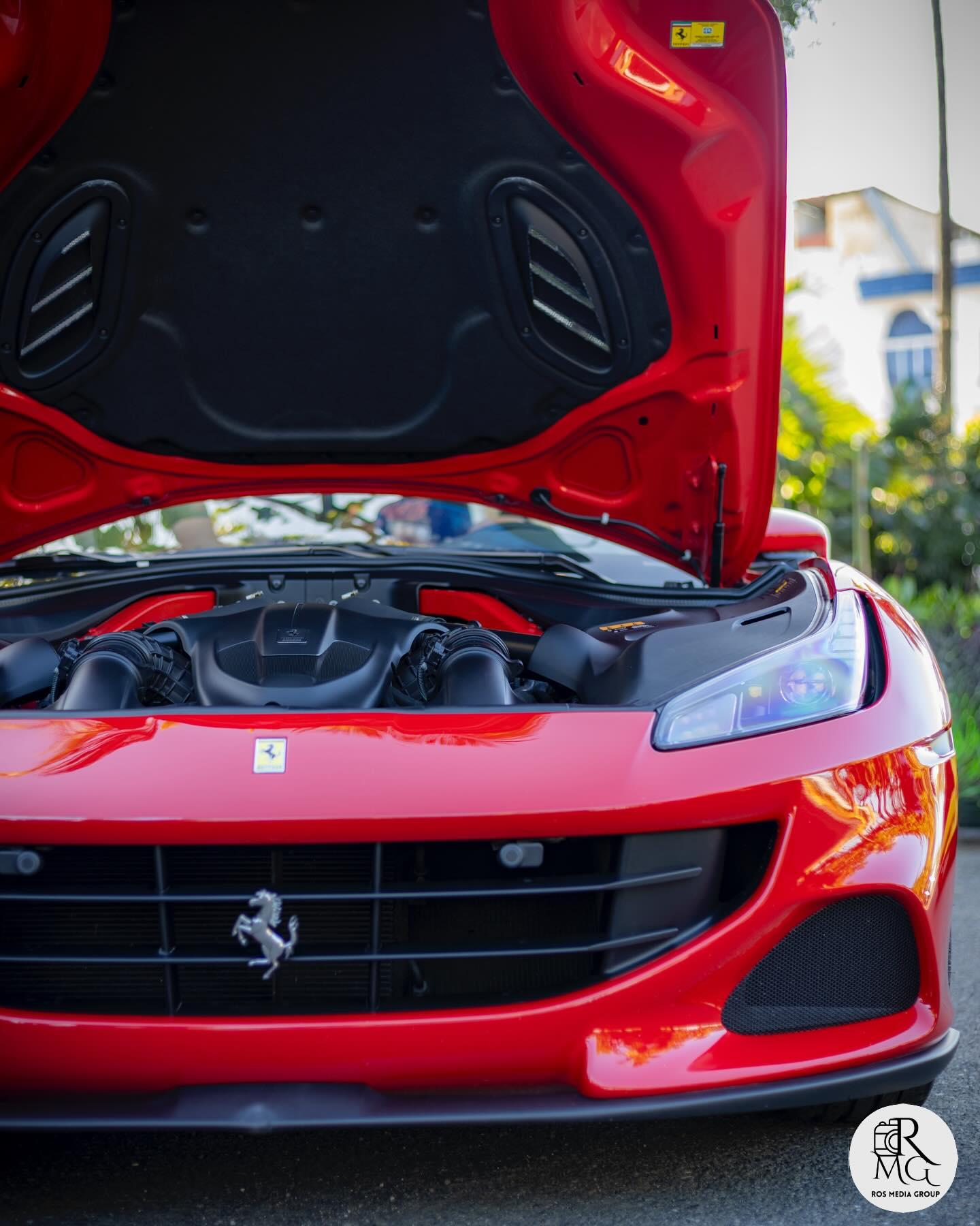 Red Ferrari seen from the front at a track event