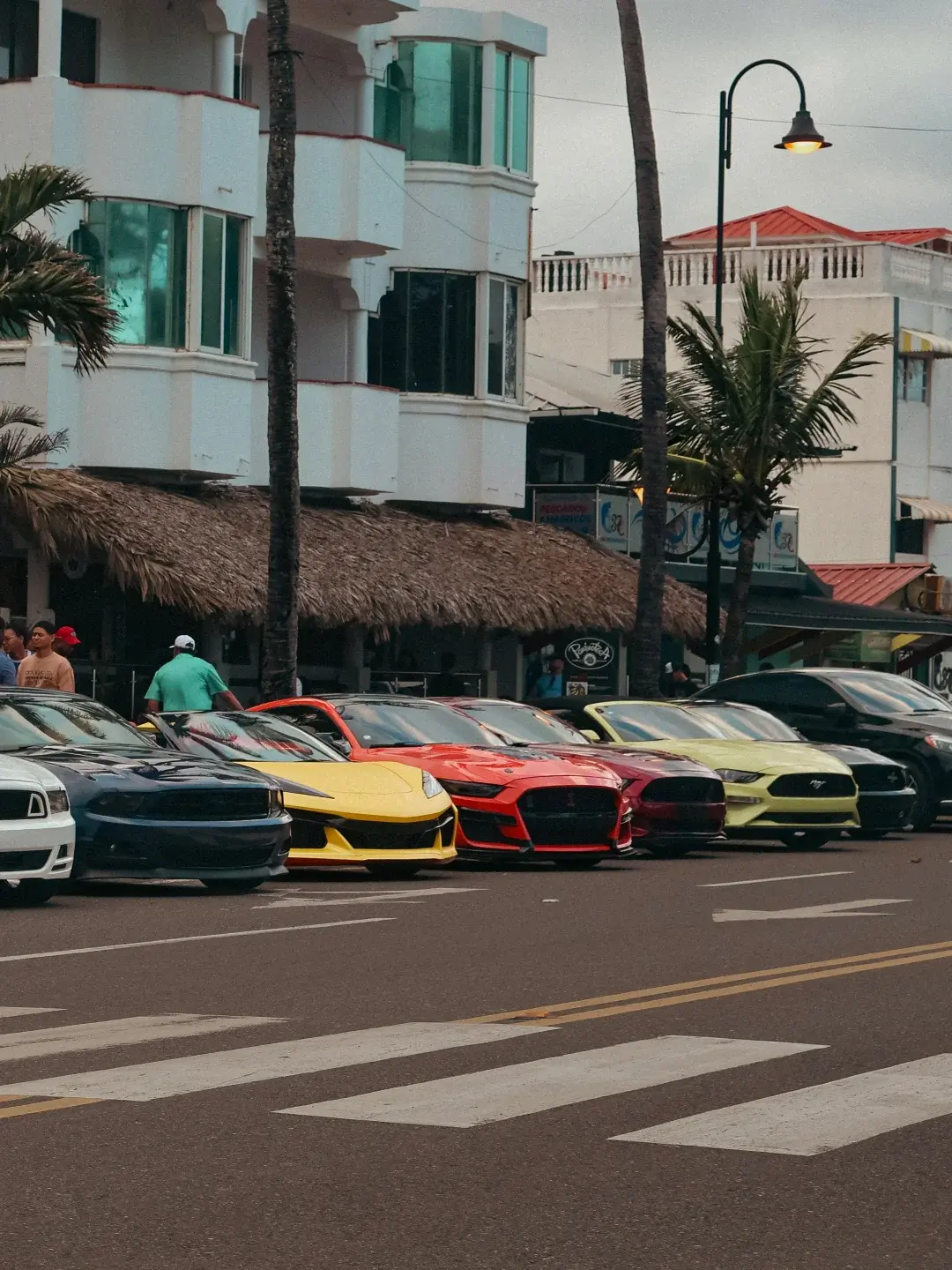 The crowd gathering in front of the cars at a club meet